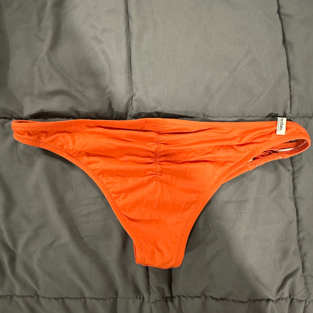 Orange bikini bathing suit bottom scrunch back. The brand is Rthym.
